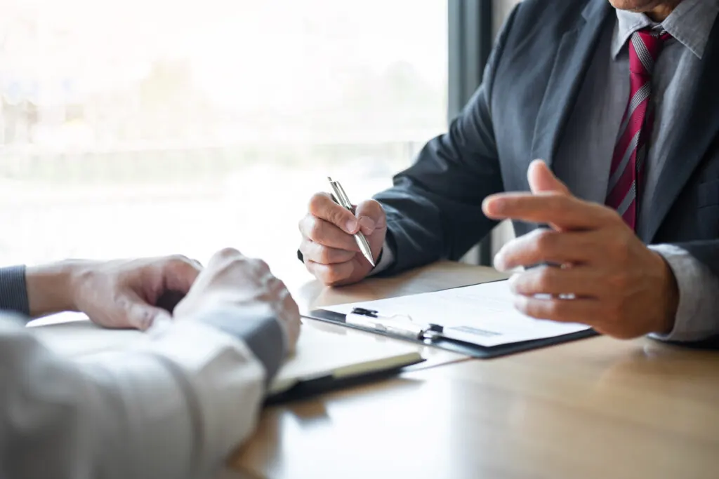 An attorney reviewing paperwork with a client