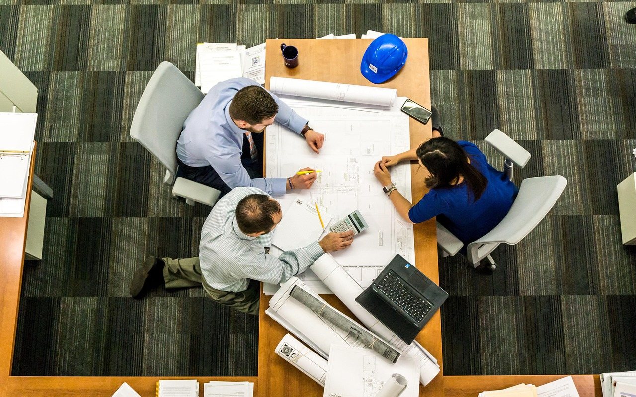 Business team reviewing plans around a conference table